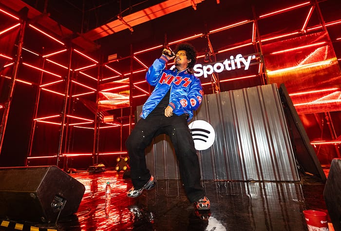 Hanumankind on a stage with red lighting, dancing and rapping