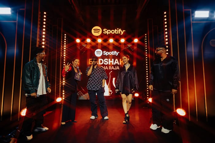 Badshah on stage with dim red lighting