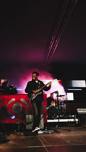 Nathan Carolus playing the guitar with a big smile on his face